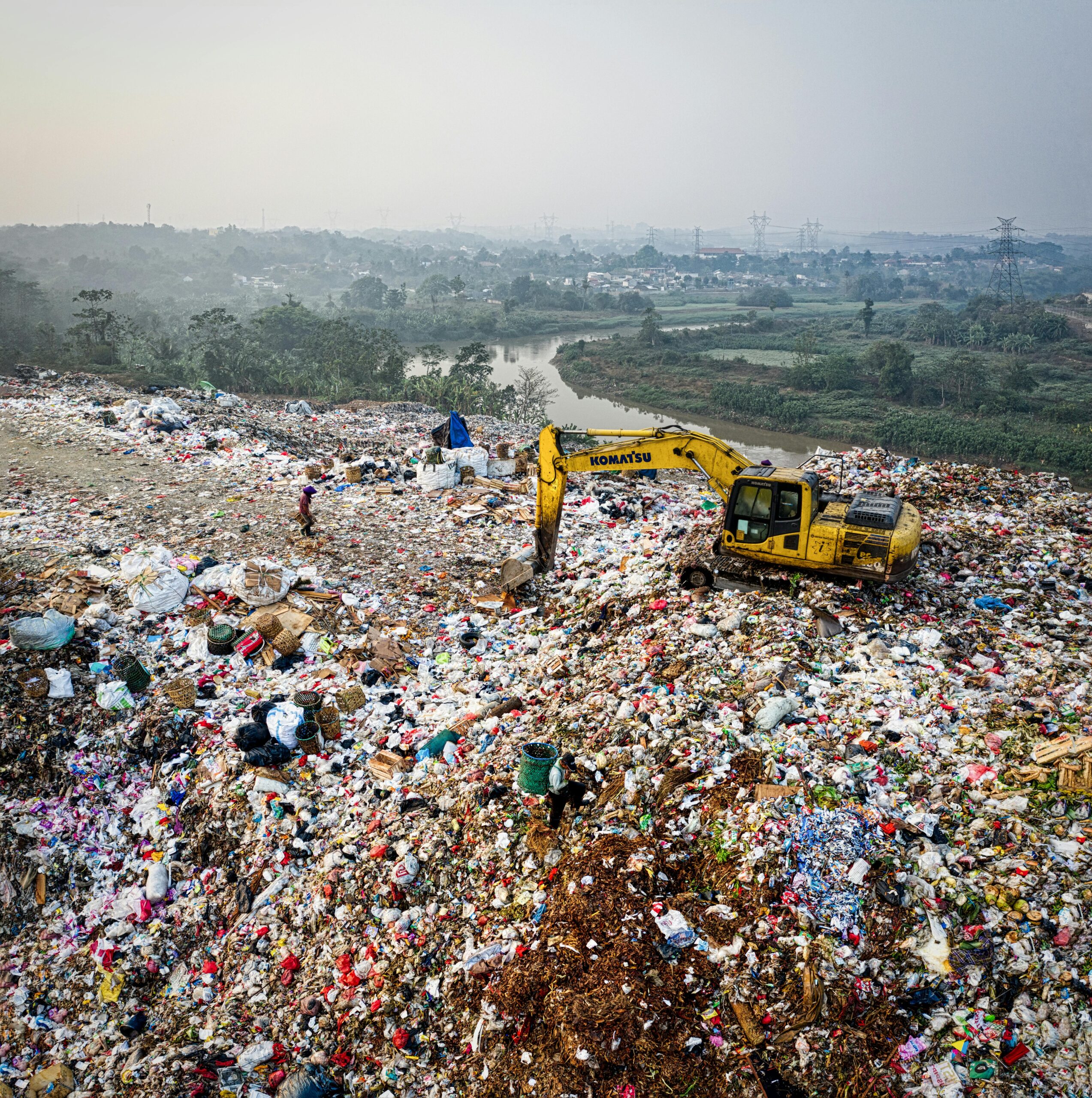 A massive landfill filled with plastic and mixed waste, showing the scale of global waste pollution and its impact on land, water, and communities.
